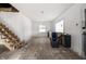 Bright living room with unfinished staircase, offering great renovation potential at 940 N Chester Ave, Indianapolis, IN 46201