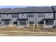 Gray townhomes feature small decks and a shared yard area at 9734 Behner Dr, Fishers, IN 46250