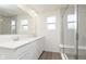 Bright bathroom with a double sink vanity, large mirror, and a glass-enclosed shower at 9734 Behner Dr, Fishers, IN 46250