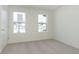 Carpeted bedroom with a double windows, carpet and a door to the hall at 9734 Behner Dr, Fishers, IN 46250