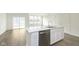 Modern kitchen features a white center island, stainless steel dishwasher, and an open floorplan at 9734 Behner Dr, Fishers, IN 46250