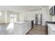 Modern kitchen boasts stainless appliances, bright white cabinets, quartz counters, and a center island at 9735 Behner Dr, Fishers, IN 46038