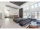 Open lobby with modern gray sofas, pendants, and kitchen area at 9735 Behner Dr, Fishers, IN 46038
