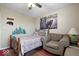 Inviting bedroom featuring nature-themed decorations and a comfortable armchair at 1002 Prairie Depot, Indianapolis, IN 46241
