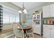 Cozy dining area with a round table, a large window, and built-in bench seating at 1002 Prairie Depot, Indianapolis, IN 46241