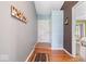 Inviting entryway featuring hardwood floors, a charming coat rack, and a welcoming color palette at 1002 Prairie Depot, Indianapolis, IN 46241