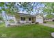 Charming home with a covered front porch, tidy landscaping, and two-car garage at 1002 Prairie Depot, Indianapolis, IN 46241