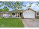 Lovely home featuring a well-maintained lawn, inviting porch, and two-car garage at 1002 Prairie Depot, Indianapolis, IN 46241