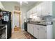 Charming kitchen featuring white cabinets, black appliances, and wood-look flooring at 1002 Prairie Depot, Indianapolis, IN 46241