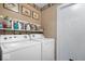 Functional laundry room with a washer, dryer, and plenty of storage space on shelving at 1002 Prairie Depot, Indianapolis, IN 46241