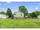 View of the backyard with a garden spot, grassy area, and full fence at 1040 Iowa St, Columbus, IN 47201