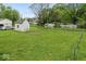 View of a large grassy backyard with a storage shed and a garden area at 1040 Iowa St, Columbus, IN 47201