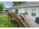 Backyard deck with stairs leading to yard, sliding glass door and basement access at 1040 Iowa St, Columbus, IN 47201