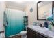 Bathroom features a vanity, tile backsplash, and curtained shower/tub at 1040 Iowa St, Columbus, IN 47201