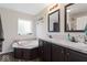 Bright bathroom with double sinks, soaking tub, and granite countertops at 1040 Iowa St, Columbus, IN 47201