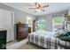 Comfortable bedroom with carpet flooring, ceiling fan and ensuite bathroom for easy access at 1040 Iowa St, Columbus, IN 47201