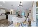 The dining room area is open to the kitchen, with a neutral color scheme and wooden floors at 1040 Iowa St, Columbus, IN 47201
