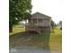 Charming home featuring a welcoming front porch, complemented by a well-maintained lawn and mature trees at 1040 Iowa St, Columbus, IN 47201