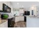 The kitchen has black appliances, white cabinets, and a light colored countertop at 1040 Iowa St, Columbus, IN 47201