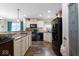 A kitchen area with black appliances, a breakfast bar, a pantry door, and modern fixtures at 1040 Iowa St, Columbus, IN 47201