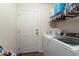Laundry room with modern washer and dryer units next to the back door at 1040 Iowa St, Columbus, IN 47201