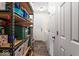 Well-organized storage room with shelving and access to the laundry area at 1040 Iowa St, Columbus, IN 47201