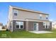 Rear view of the home highlighting the brickwork, siding, patio and level lot at 10448 Pintail Ln, Indianapolis, IN 46239