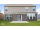 Backyard featuring a brick section, concrete patio, and an ample grass area at 10448 Pintail Ln, Indianapolis, IN 46239