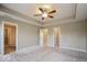 Spacious carpeted bedroom featuring a trey ceiling with ceiling fan and neutral walls at 10448 Pintail Ln, Indianapolis, IN 46239