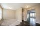 Spacious bedroom with neutral walls, plush carpet, and a glimpse into a room with hardwood floors at 10448 Pintail Ln, Indianapolis, IN 46239