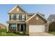 Charming two-story home featuring a two-car garage and nicely landscaped front yard at 10448 Pintail Ln, Indianapolis, IN 46239