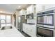 Well-equipped kitchen with modern appliances, light-colored cabinets, and a view of the staircase at 10448 Pintail Ln, Indianapolis, IN 46239