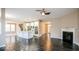 Open concept living room featuring hardwood floors, a fireplace, and seamless access to the kitchen at 10448 Pintail Ln, Indianapolis, IN 46239