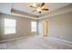 Expansive primary bedroom with tray ceilings, natural light, and neutral color scheme at 10448 Pintail Ln, Indianapolis, IN 46239