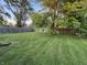 Well-maintained backyard featuring lush grass, mature trees, and a wood fence. Great outdoor space! at 107 N Grant St, Brownsburg, IN 46112