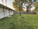Large backyard with lush green grass and a wood fence, perfect for outdoor activities at 107 N Grant St, Brownsburg, IN 46112