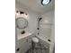 Modern bathroom with white vanity, round mirror, and beautiful patterned tile floor at 107 N Grant St, Brownsburg, IN 46112
