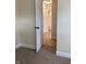 View from bedroom into bathroom with new flooring, new toilet, and shower with white tile at 107 N Grant St, Brownsburg, IN 46112