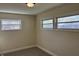 Bedroom featuring neutral carpeting, fresh paint, and two windows for natural light at 107 N Grant St, Brownsburg, IN 46112