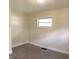 Cozy bedroom with neutral carpeting, fresh paint, and a window for natural light at 107 N Grant St, Brownsburg, IN 46112
