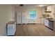 Eat-in kitchen featuring modern cabinets, new flooring, and a window over the sink at 107 N Grant St, Brownsburg, IN 46112