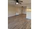 Spacious living room with ceiling fan, new flooring, and ample space for entertaining at 107 N Grant St, Brownsburg, IN 46112