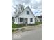 Quaint two-story home featuring a covered porch and well-kept lawn, radiating a cozy charm at 11 W Osage St, Greenfield, IN 46140