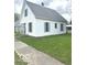 Classic home showcasing a neat yard, offering a blend of comfort and traditional design at 11 W Osage St, Greenfield, IN 46140