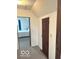 Hallway leading to a bedroom with carpet and neutral-colored walls at 11 W Osage St, Greenfield, IN 46140