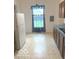 Bright kitchen featuring blue curtains and tile floors, creating a clean and practical space at 11 W Osage St, Greenfield, IN 46140