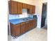 Functional kitchen featuring ample wooden cabinets, blue countertops, and essential appliances at 11 W Osage St, Greenfield, IN 46140