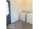Laundry room with updated machines and convenient side door access at 11 W Osage St, Greenfield, IN 46140