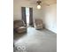 Living room featuring two cozy chairs, neutral walls, and a ceiling fan at 11 W Osage St, Greenfield, IN 46140