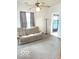 Bright living room with a comfortable couch, tall lamp, and natural lighting at 11 W Osage St, Greenfield, IN 46140